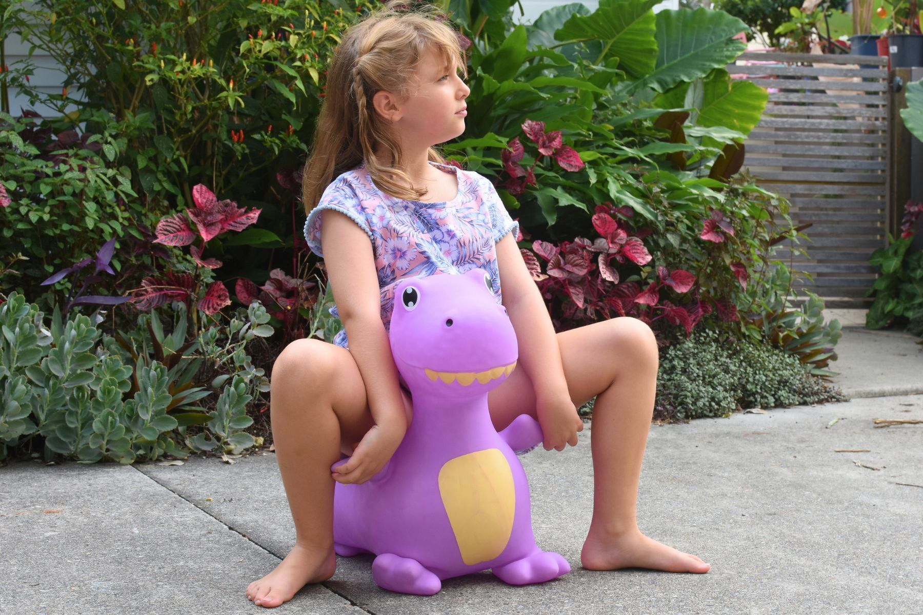 Bouncy Rider Periwinkle the T-Rex – Inflatable purple T-Rex ride-on by Kaper Kidz for toddlers (12 months+), with sturdy grip handles, hand pump included, supports up to 50 kg, and meets safety standards.