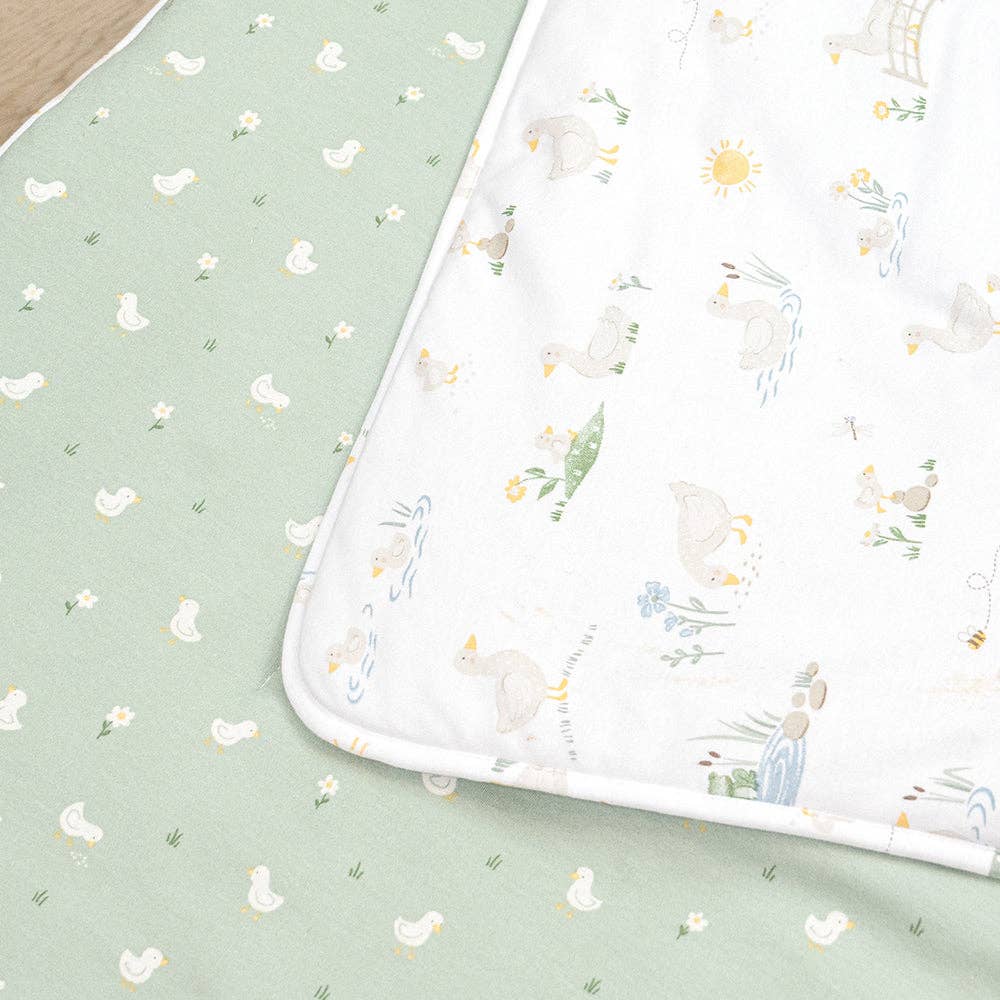 Living Textiles Deluxe Nap Mat – Goosey Goosey design on sage‑tone organic cotton jersey with built‑in pillow and blanket, quilted base, four elastic loops for daycare stacker beds, carry handle and name label