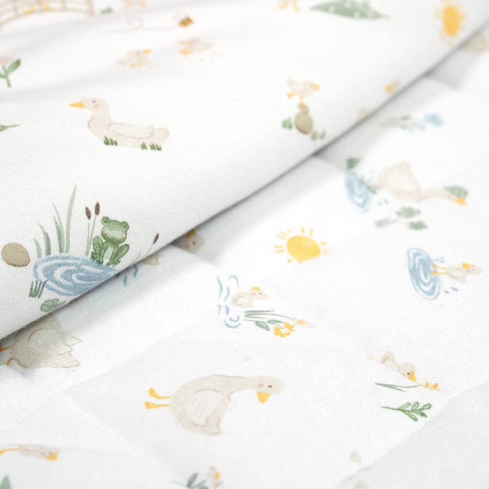 Living Textiles Deluxe Nap Mat – Goosey Goosey design on sage‑tone organic cotton jersey with built‑in pillow and blanket, quilted base, four elastic loops for daycare stacker beds, carry handle and name label