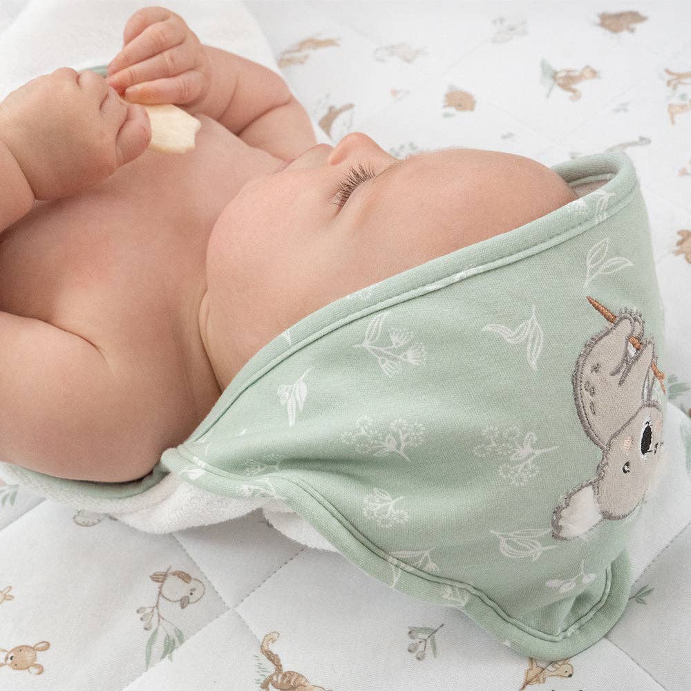 Living Textiles Organic Hooded Towel – Australiana design featuring native animals and botanical embroidery in calming sage tones; made from 100% organic cotton terry with soft jersey hood for cozy post-bath snuggles