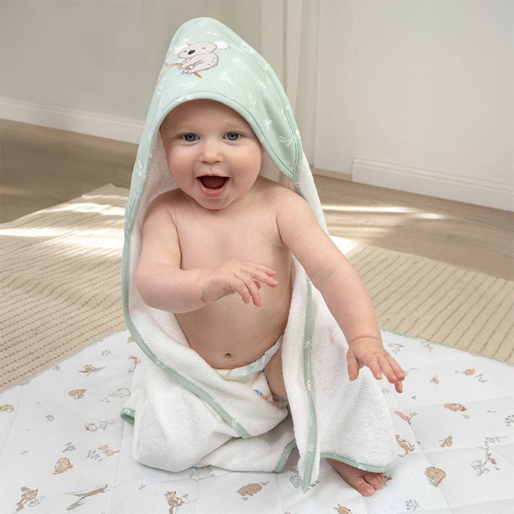 Living Textiles Organic Hooded Towel – Australiana design featuring native animals and botanical embroidery in calming sage tones; made from 100% organic cotton terry with soft jersey hood for cozy post-bath snuggles