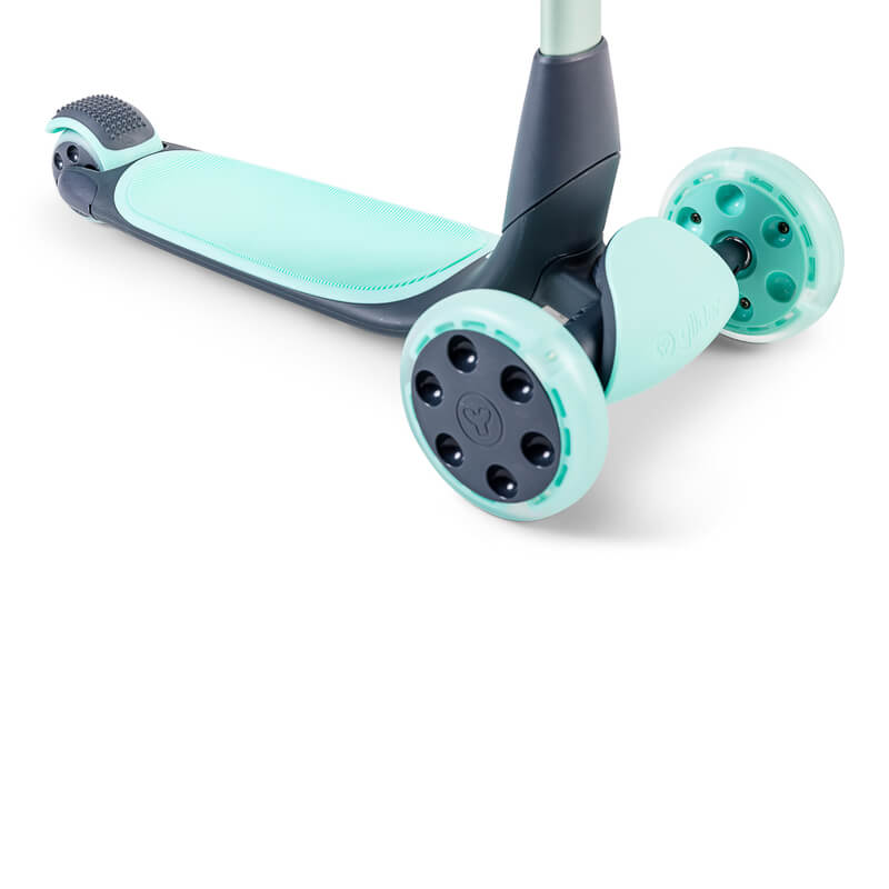 YGlider Nua green 2‑in‑1 foldable lean‑to‑steer scooter – lightweight kids’ scooter with adjustable arc‑folding handlebar, LED front wheels, wide rear wheel and wall‑mount accessory
