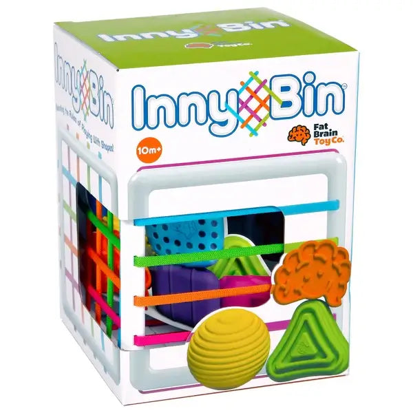 Fat Brain Toys InnyBin – sensory shape‑exploration cube with six chunky, textured blocks (cube, diamond, sphere, triangle, flower, logo) and elastic bands for frustration‑free fine motor play