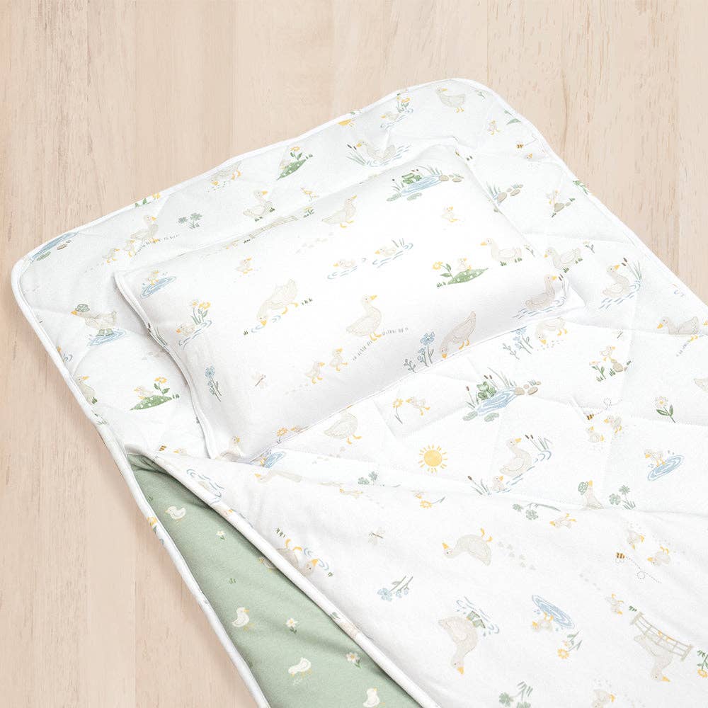 Living Textiles Deluxe Nap Mat – Goosey Goosey design on sage‑tone organic cotton jersey with built‑in pillow and blanket, quilted base, four elastic loops for daycare stacker beds, carry handle and name label