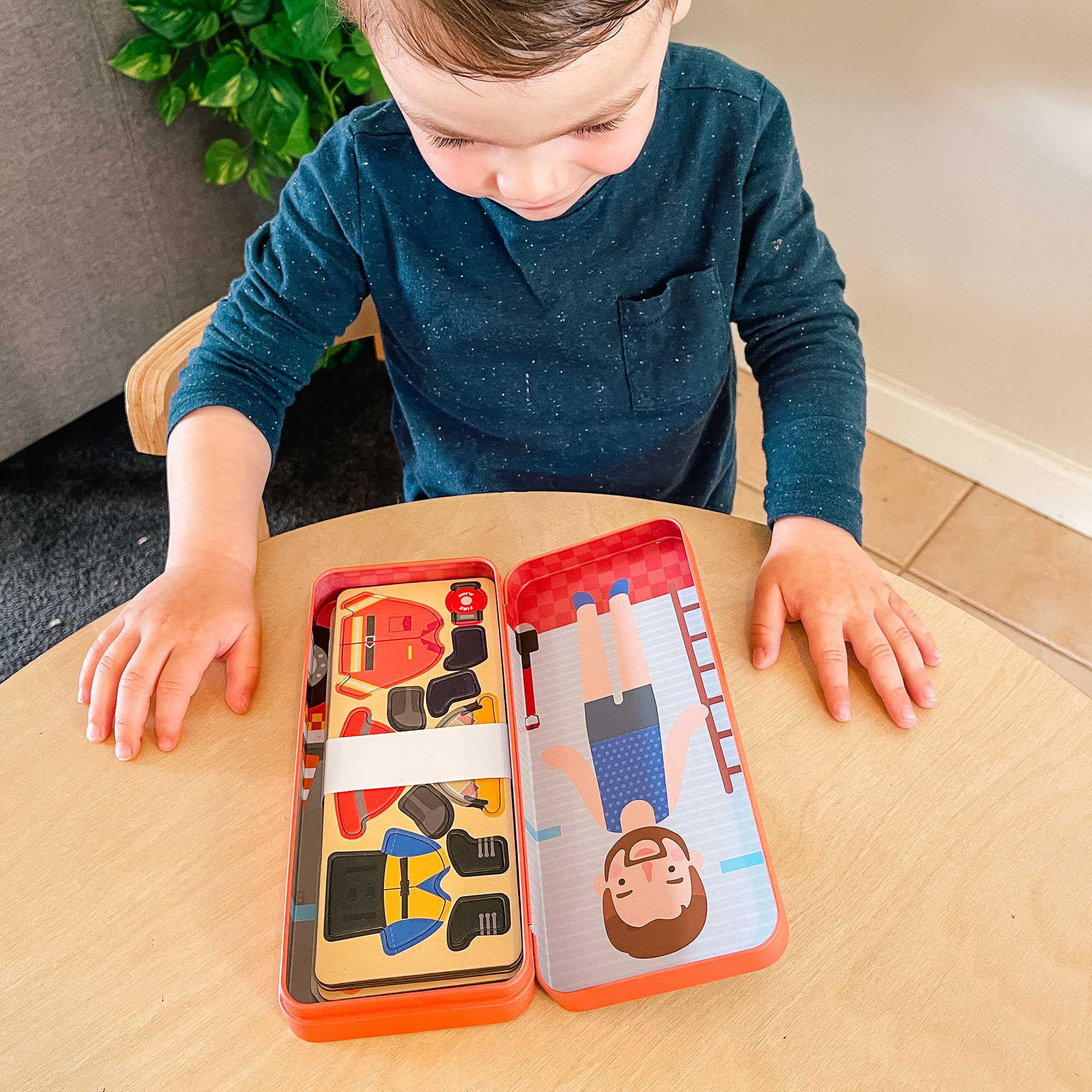 MierEdu Magnetic Puzzle Box – Firefighter edition featuring 32 magnetic dress-up pieces and two illustrated play scenes in a portable tin, perfect for imaginative storytelling and fine motor skill development