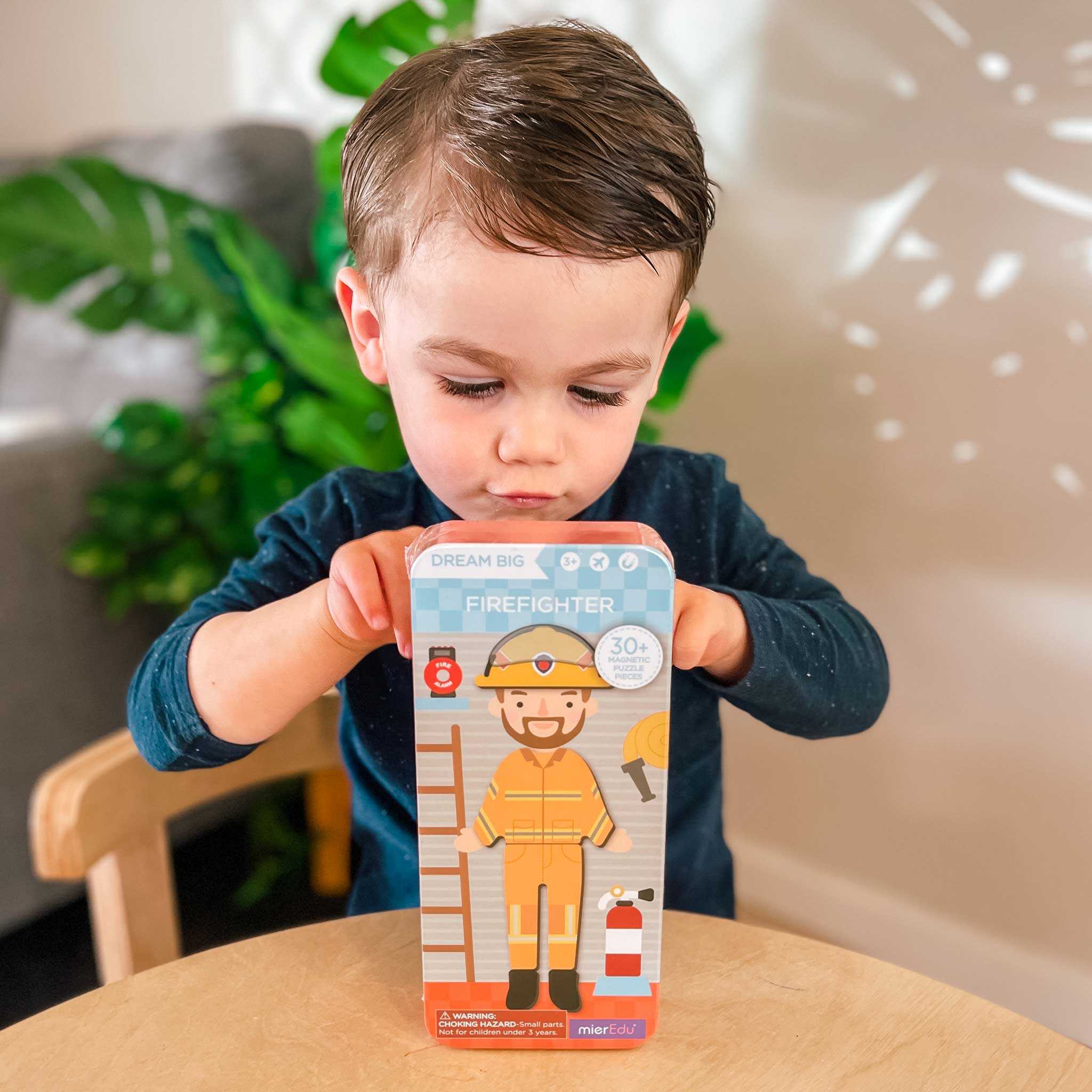 MierEdu Magnetic Puzzle Box – Firefighter edition featuring 32 magnetic dress-up pieces and two illustrated play scenes in a portable tin, perfect for imaginative storytelling and fine motor skill development