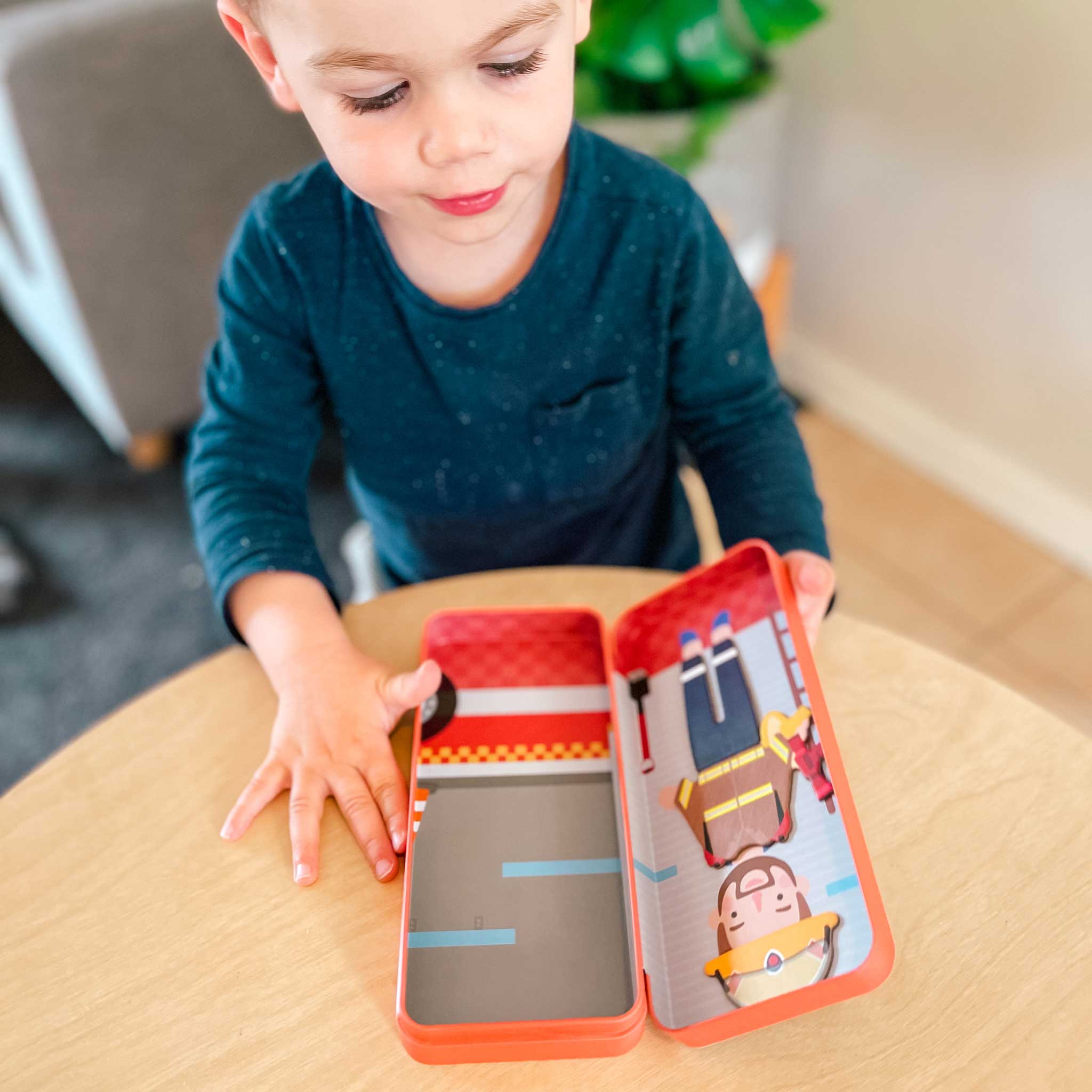 MierEdu Magnetic Puzzle Box – Firefighter edition featuring 32 magnetic dress-up pieces and two illustrated play scenes in a portable tin, perfect for imaginative storytelling and fine motor skill development